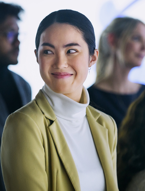 a person in a white turtleneck and a yellow jacket