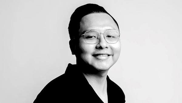a person wearing glasses and smiling