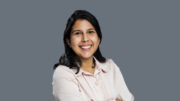 a person smiling with her arms crossed