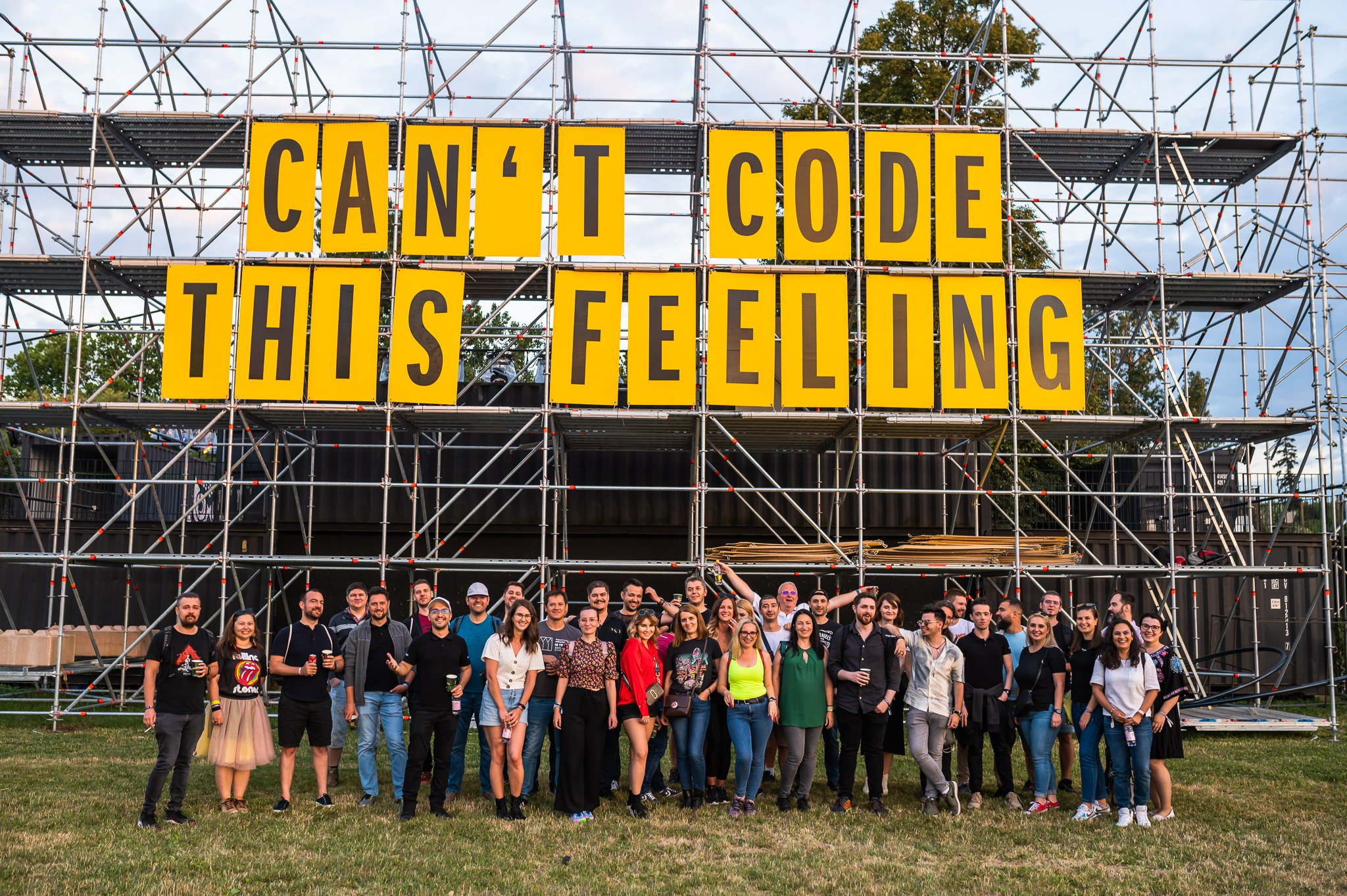 a group of people standing in front of a scaffolding