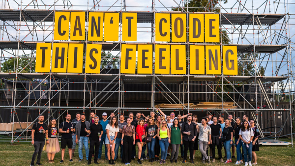 a group of people standing in front of a scaffolding