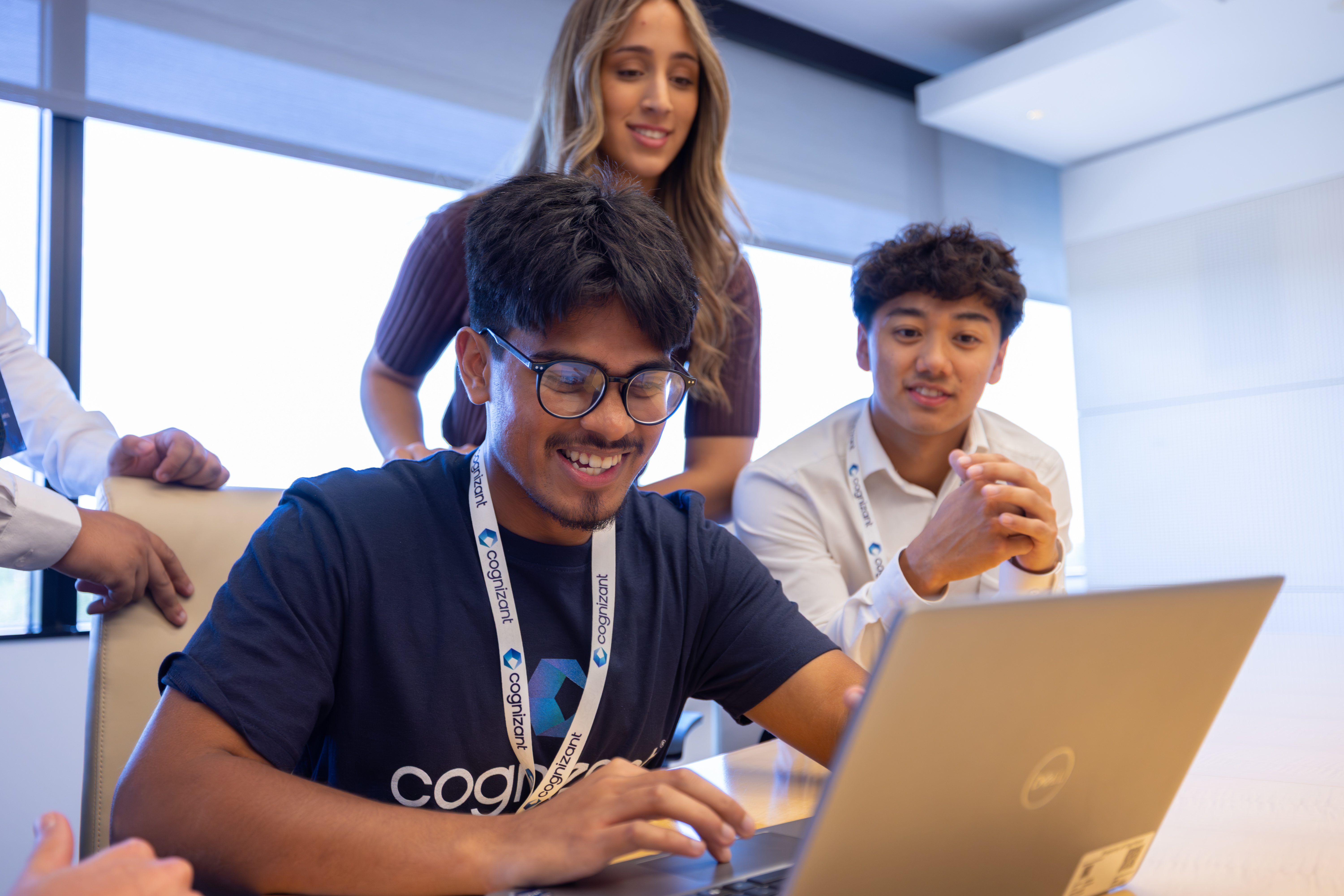 a group of people looking at a laptop