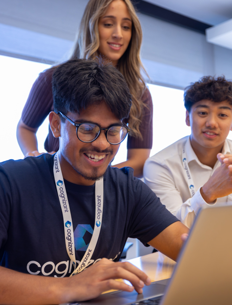 a group of people looking at a laptop