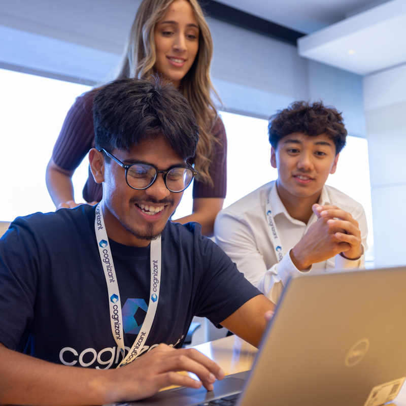 a group of people looking at a laptop