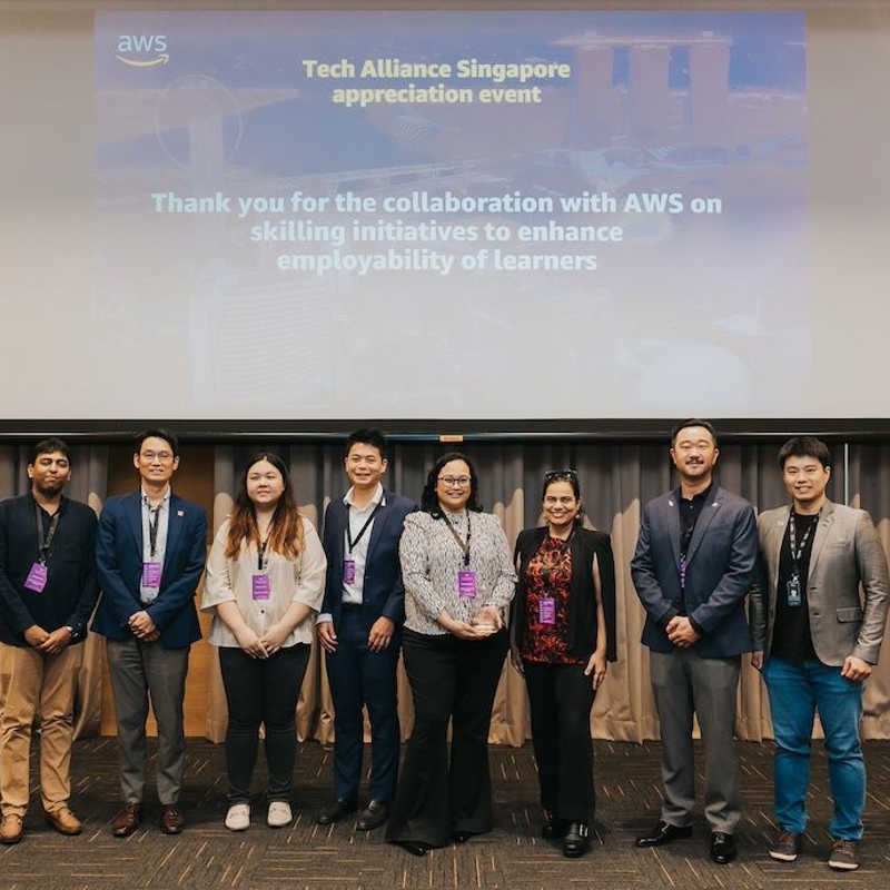 a group of people standing in front of a projector screen
