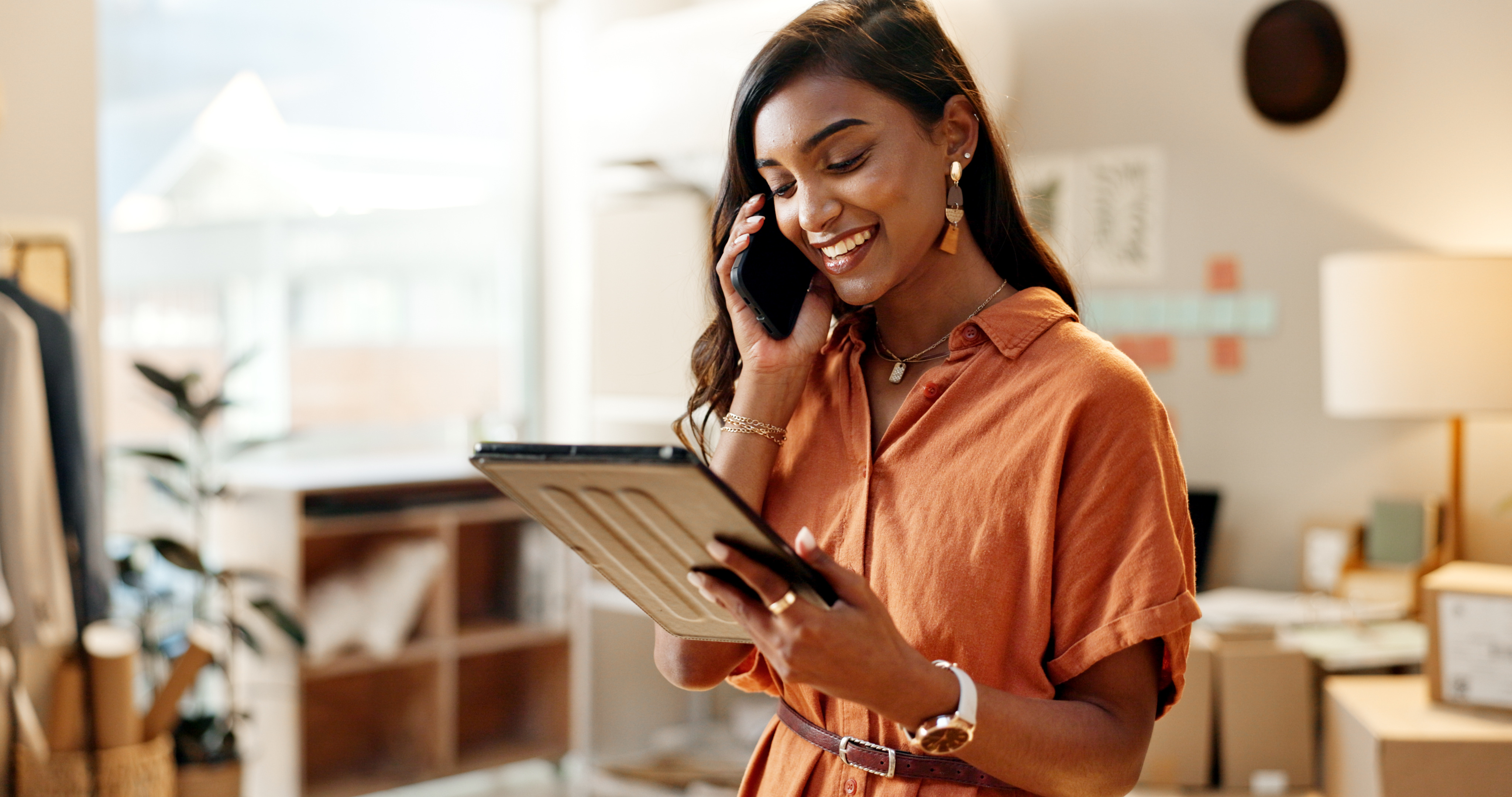 a person holding a tablet and talking on the phone