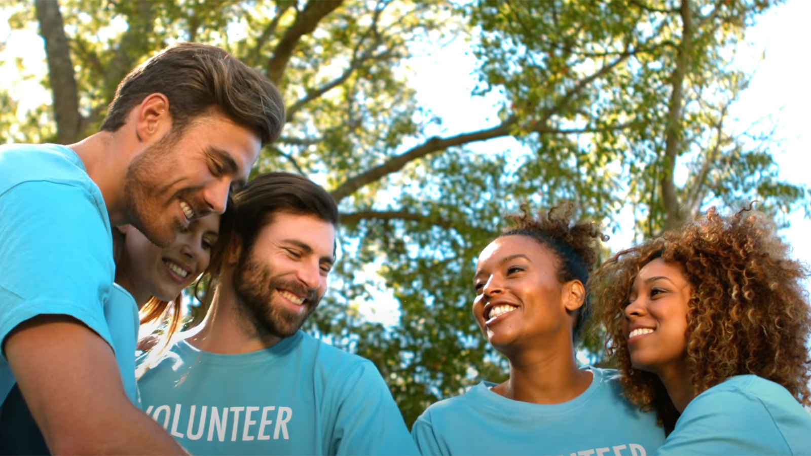 a group of people in blue shirts