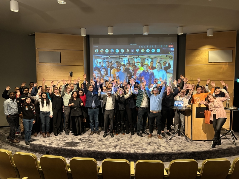 a group of people standing on a stage with their hands up