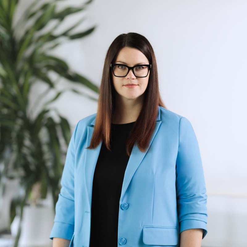 a person wearing glasses and a blue jacket