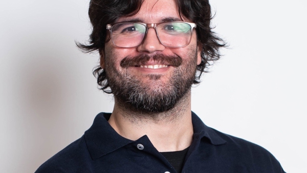 a person with glasses smiling