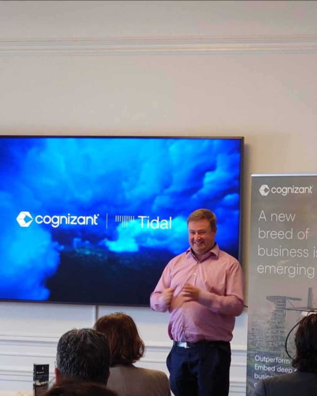 a person standing in front of a large screen