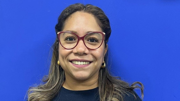 a person wearing glasses smiling