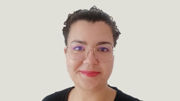 a person wearing glasses and smiling
