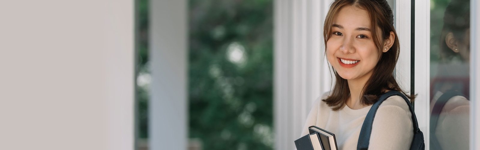 a person holding books and smiling
