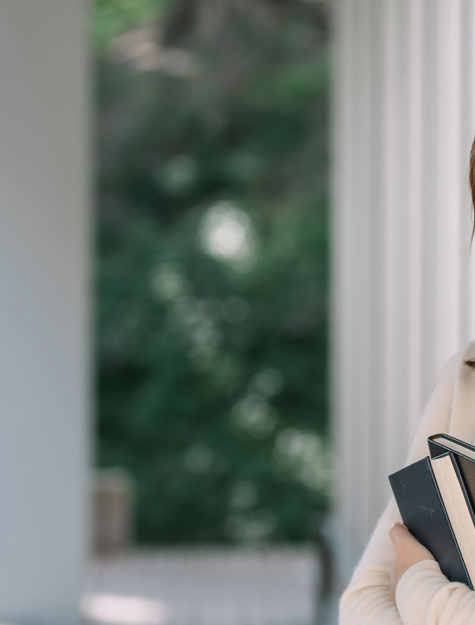 a person holding books and smiling