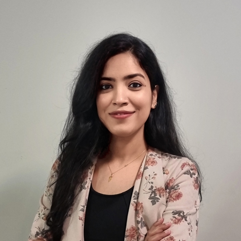 a person with long black hair and a floral jacket