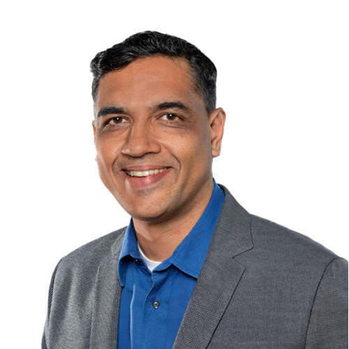 a person in a blue shirt and gray jacket