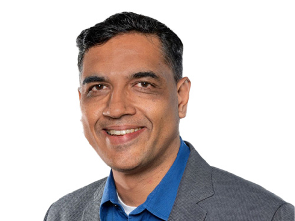 a person in a blue shirt and gray jacket