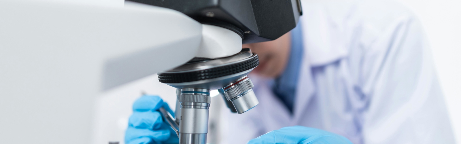 a person looking through a microscope