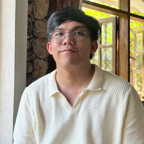 a person wearing glasses and a white shirt