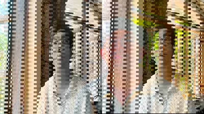 a person wearing glasses and a white shirt