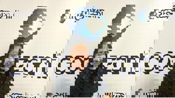 a person standing in front of a sign
