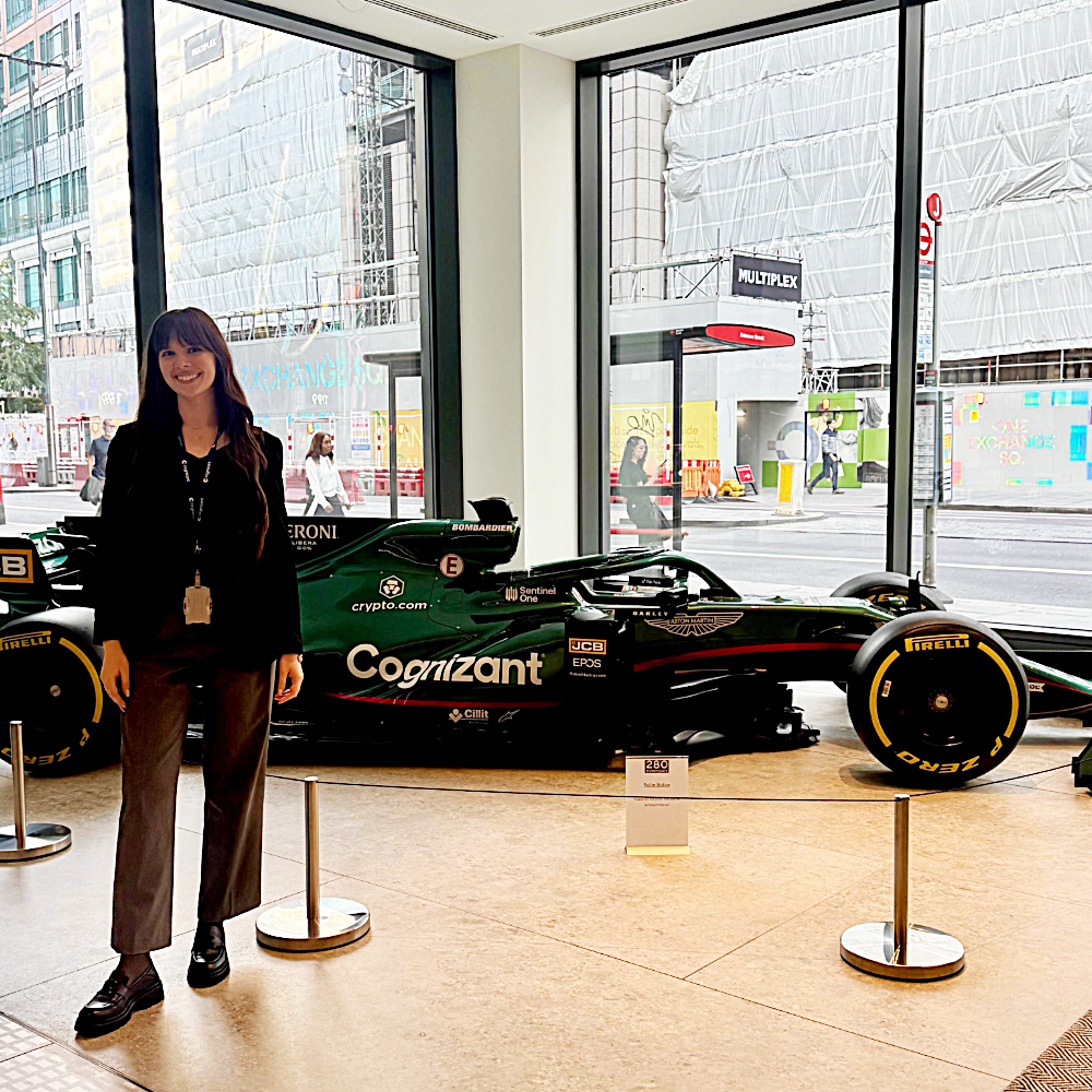 a person standing in front of a race car