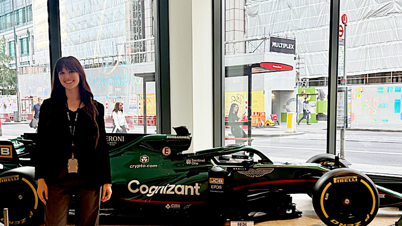 a person standing in front of a race car