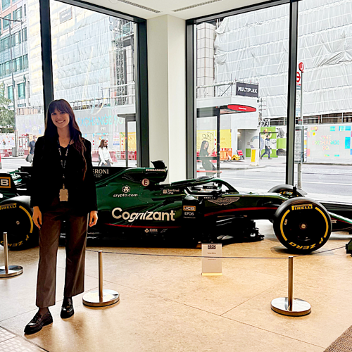 a person standing in front of a race car