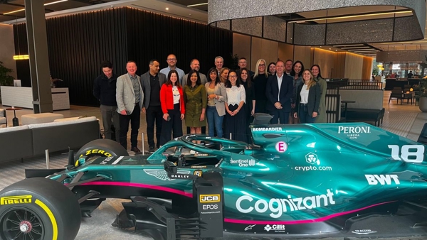 a group of people standing in front of a race car