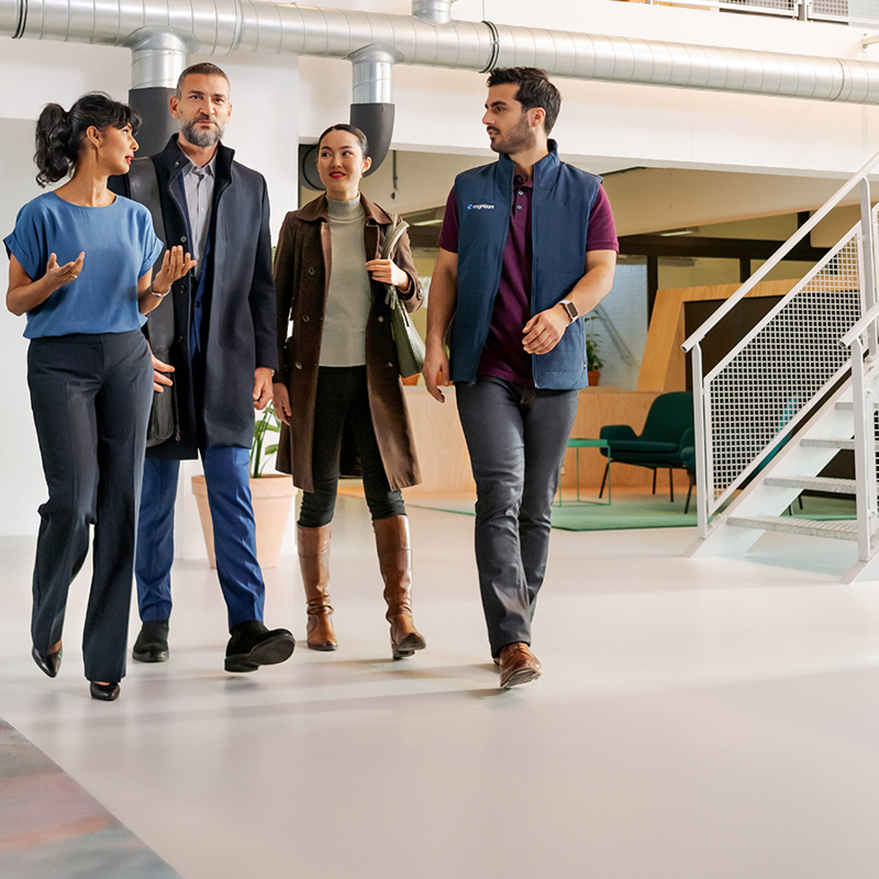 a group of people walking in a hallway