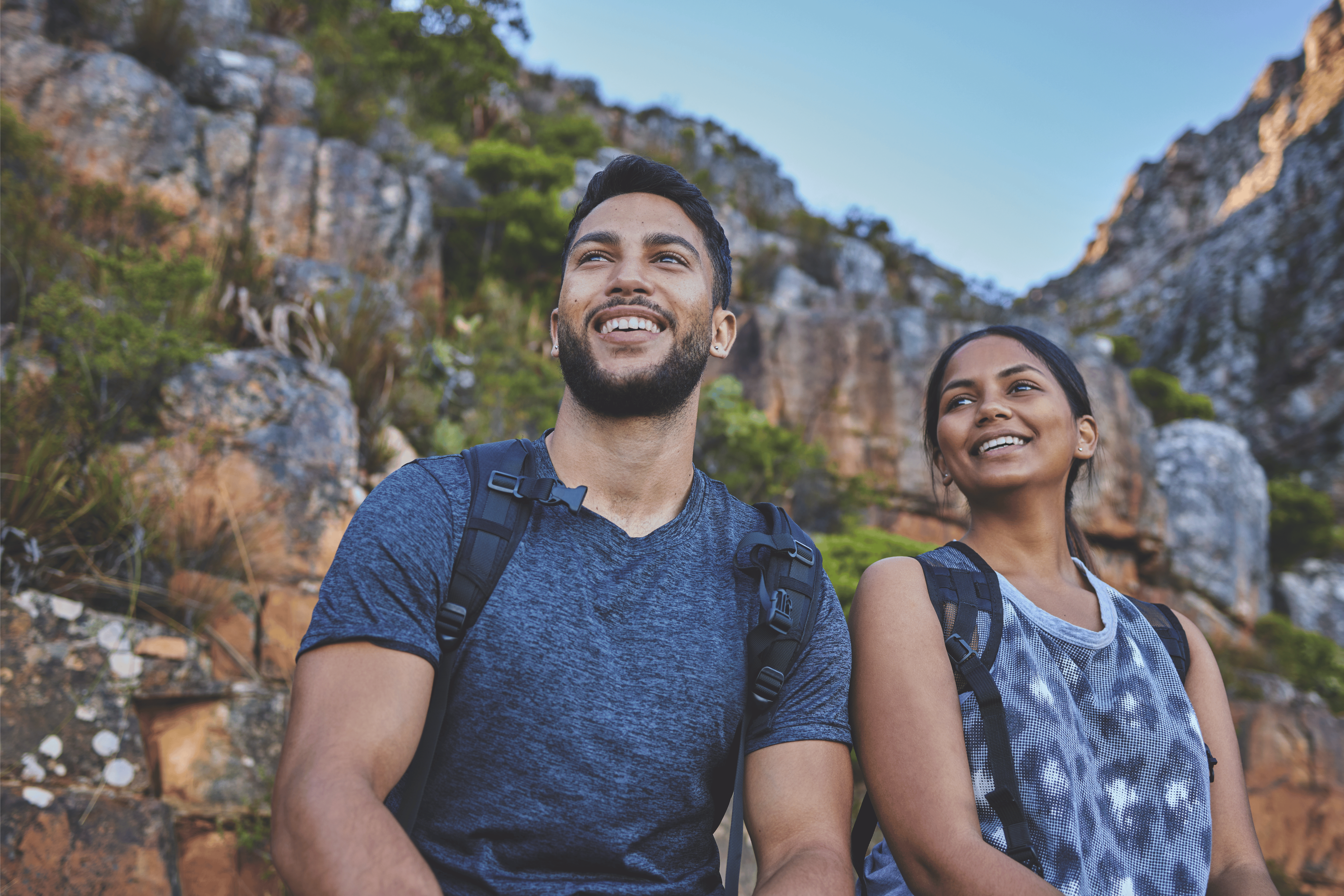 a person and person sitting on a rock