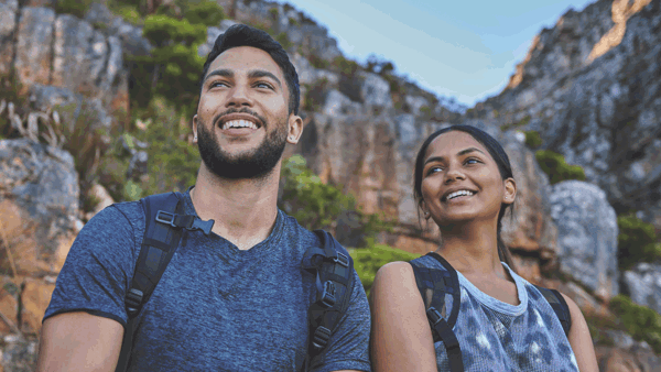 a person and person sitting on a rock
