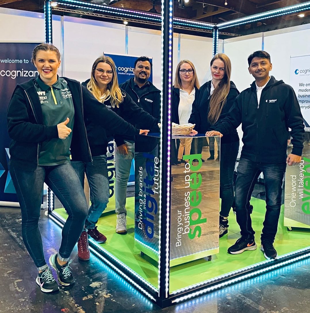a group of people standing in front of a glass box