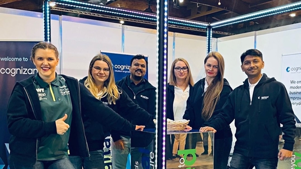 a group of people standing in front of a glass box
