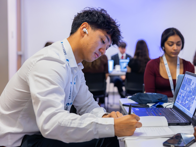 a person writing on a notebook