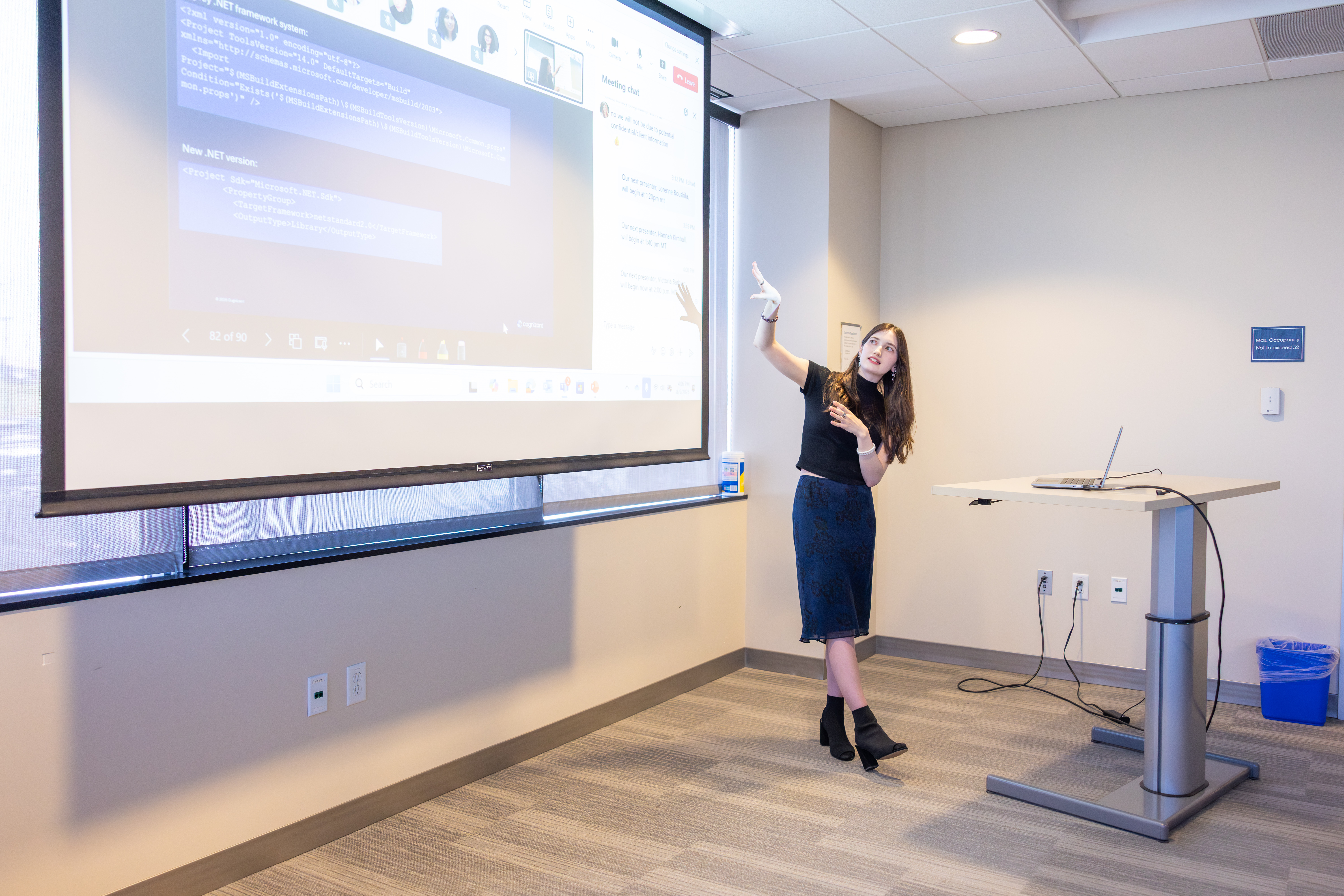 a person standing in front of a projector screen
