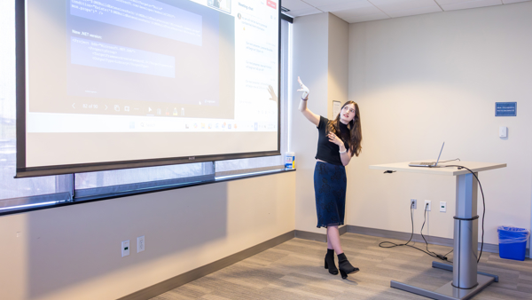 a person standing in front of a projector screen
