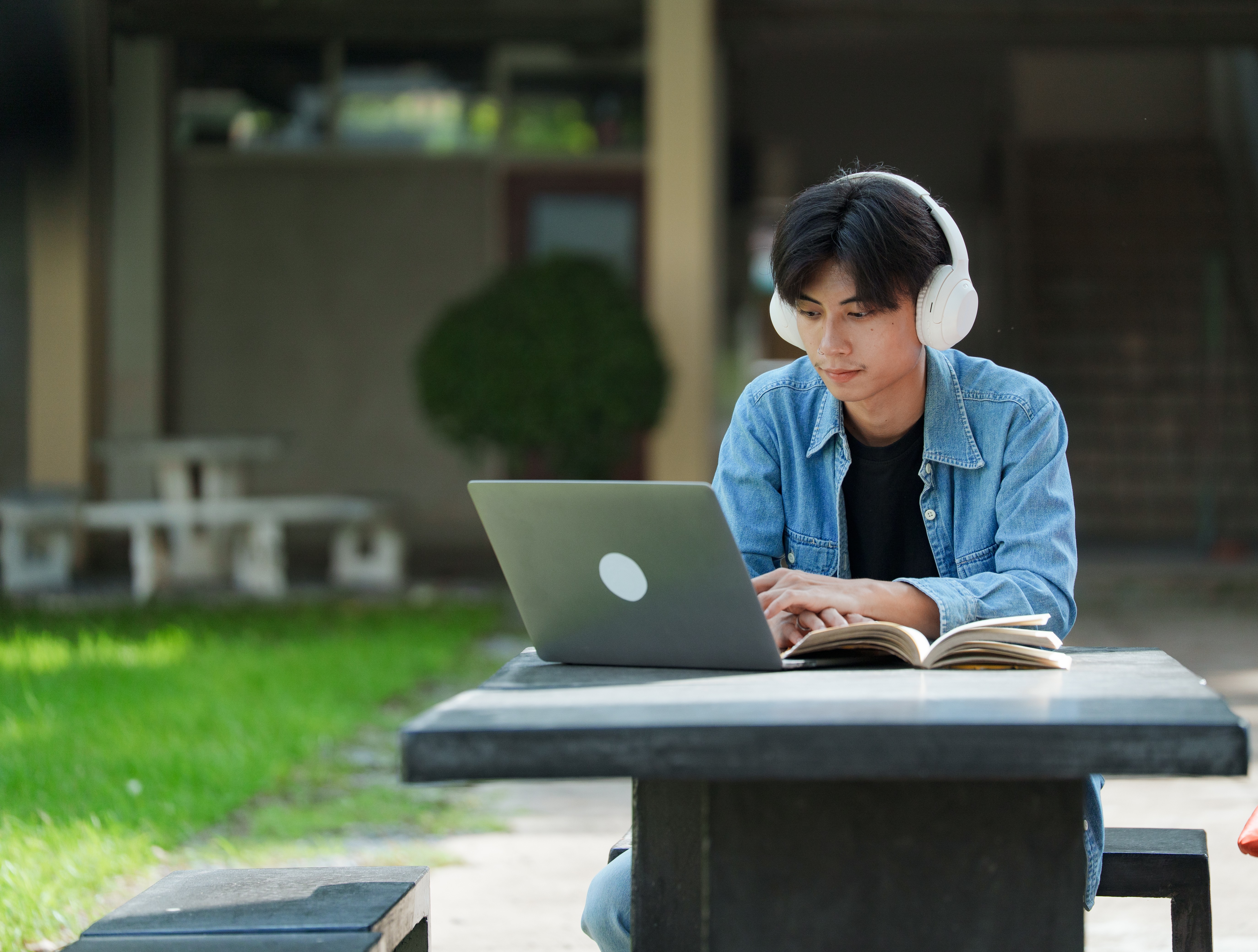 a person wearing headphones and using a laptop