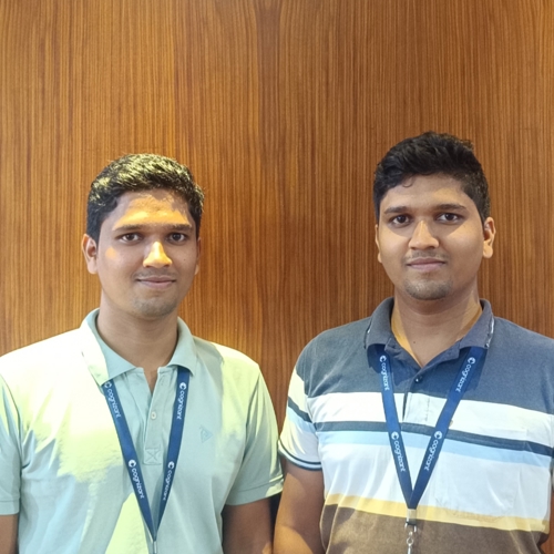 two men standing together in front of a wood wall