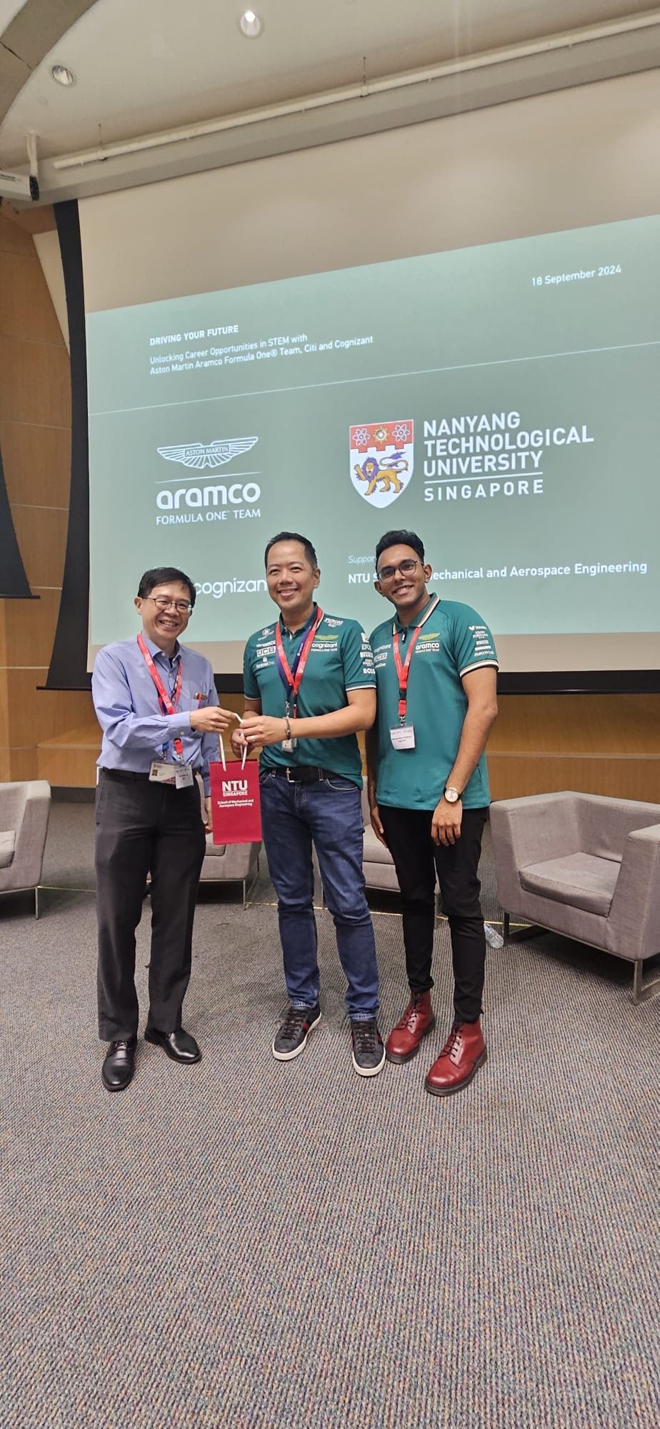 a group of men standing in front of a projector screen