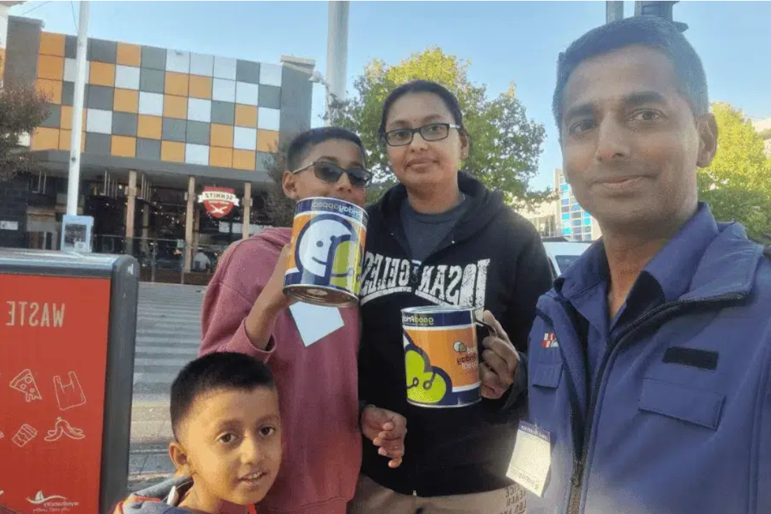 a group of people holding cans