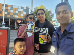 a group of people holding cans