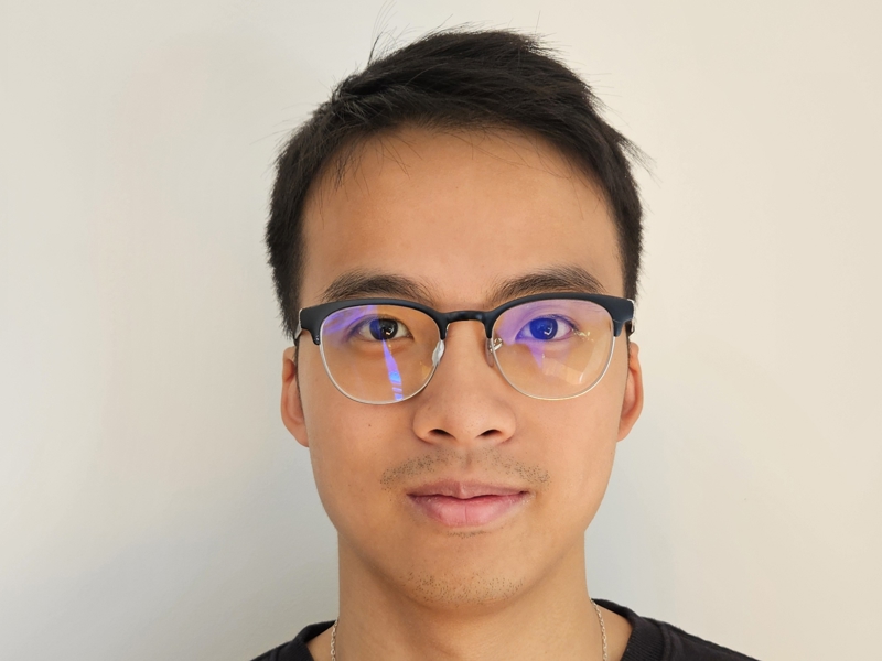 a person wearing glasses and smiling