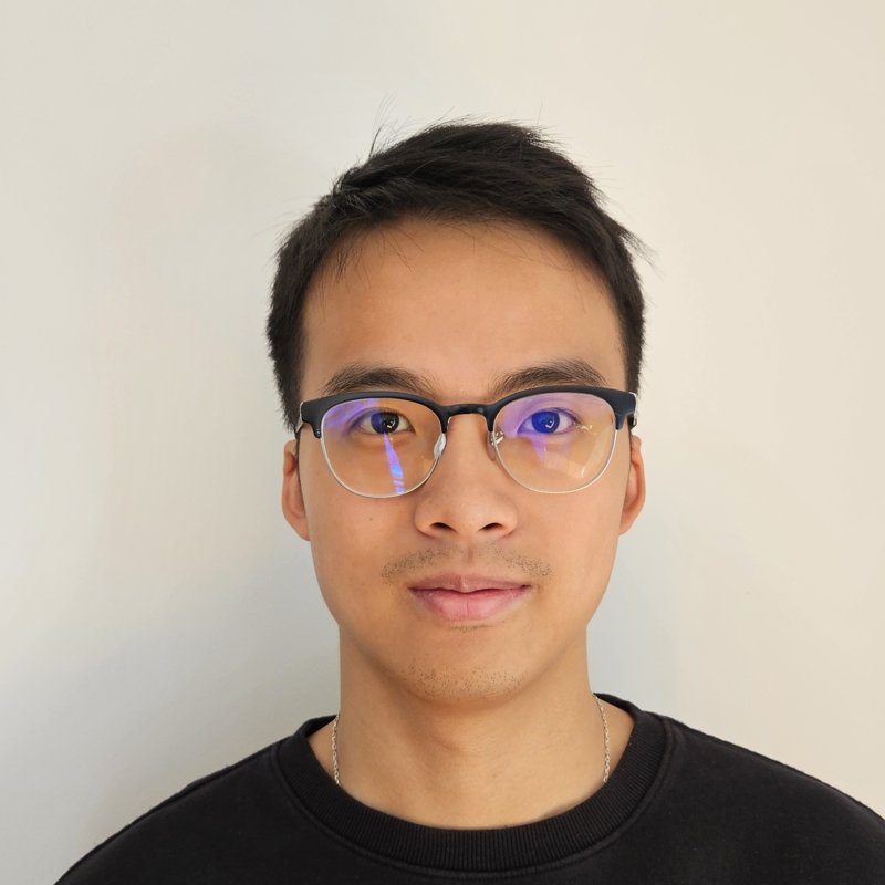 a person wearing glasses and smiling