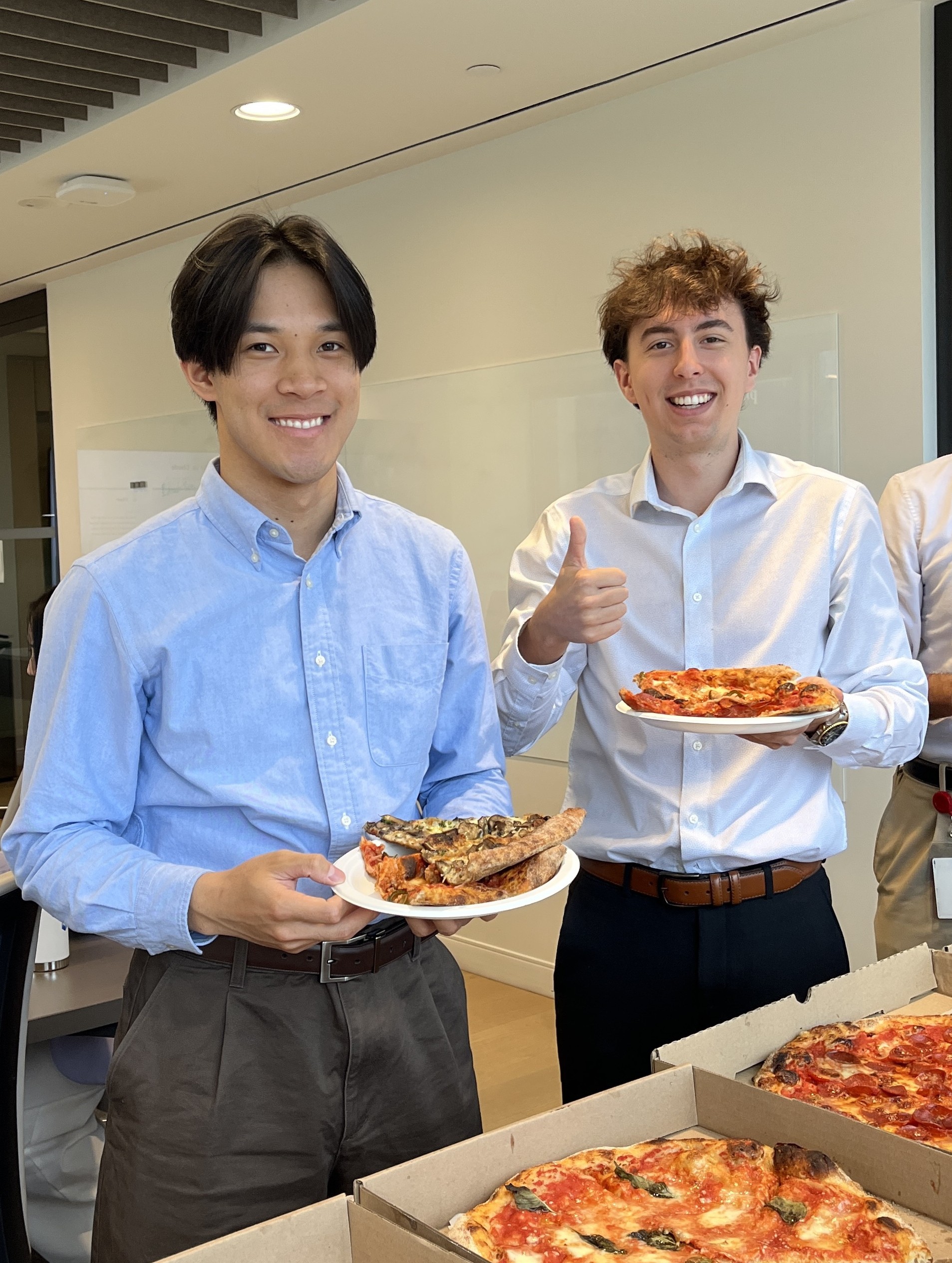 two men holding plates of food
