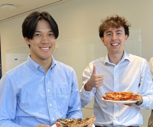 two men holding plates of food