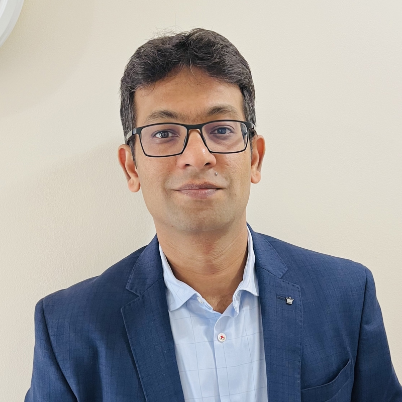 a person wearing glasses and a suit