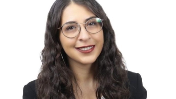 a person wearing glasses and a suit