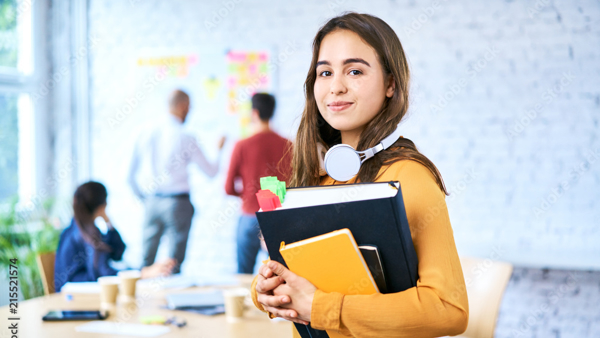 a person holding books and headphones